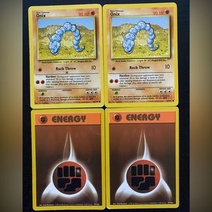 Two Onix 56/102 Pokémon Cards and Two Fighting Energy Cards